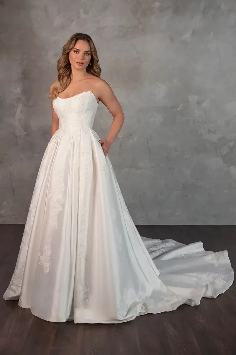 model is wearing a strapless ball gown