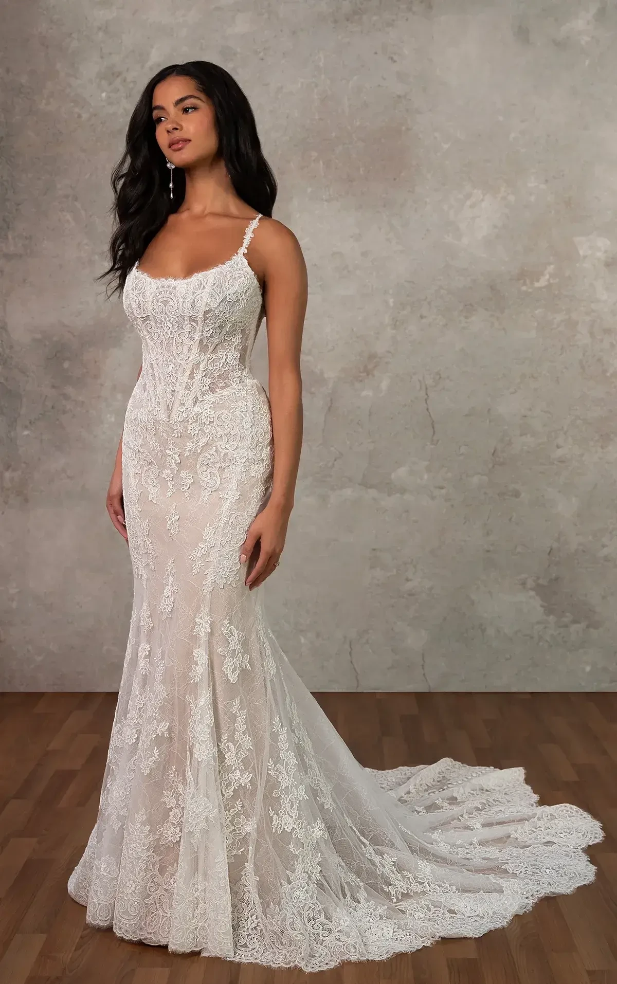 model is wearing a sleeveless lace fit and flare bridal gown